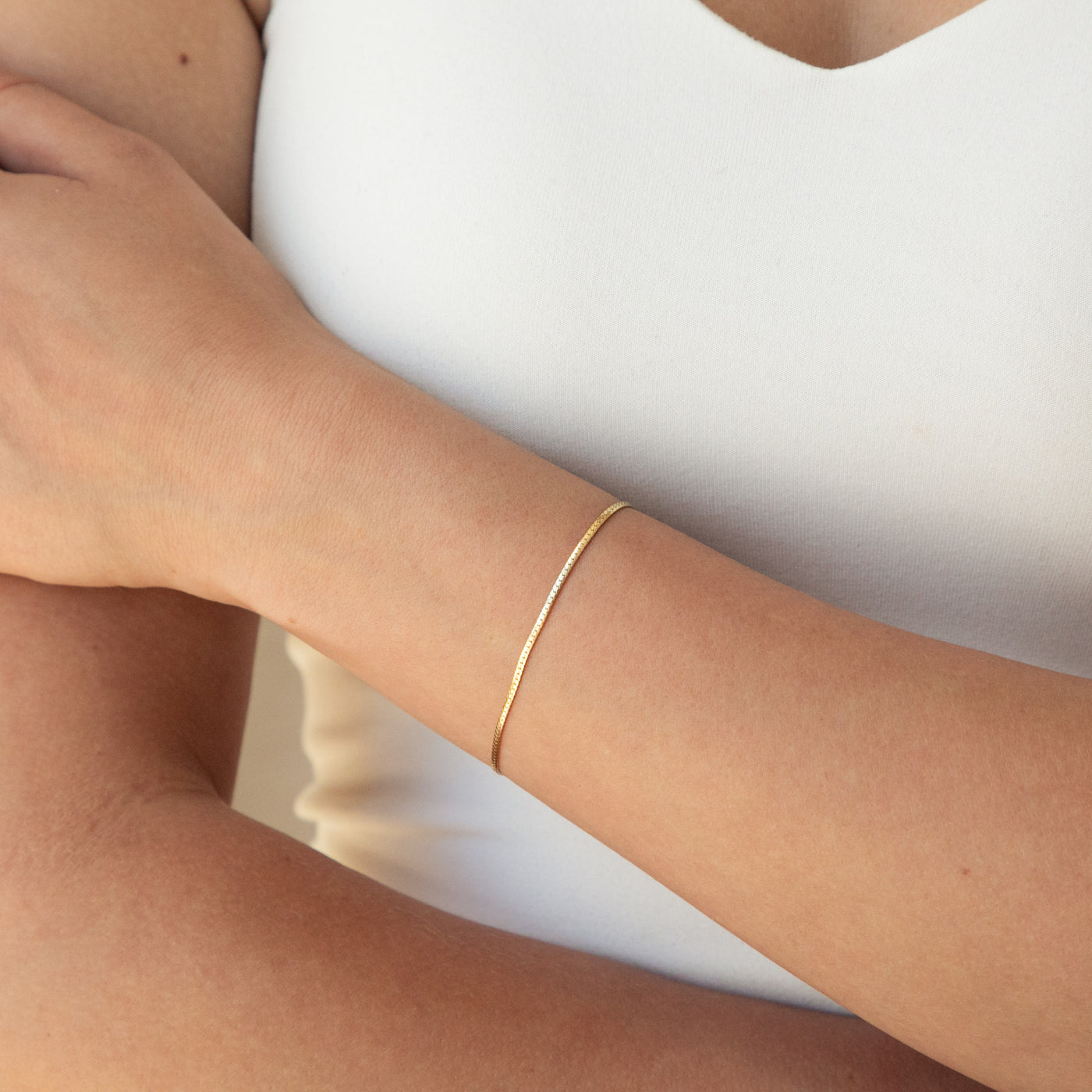 Dainty Herringbone Bracelet on woman's wrist