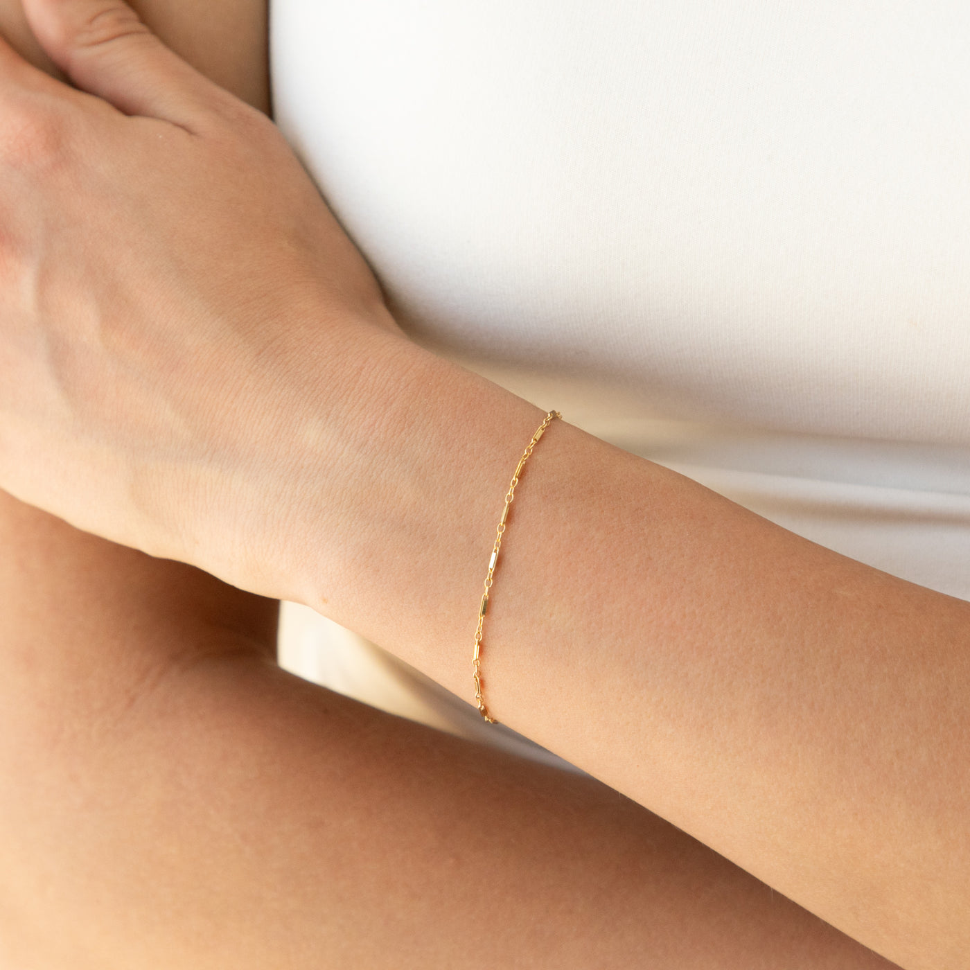 woman's wrist with sparkly chain bracelet