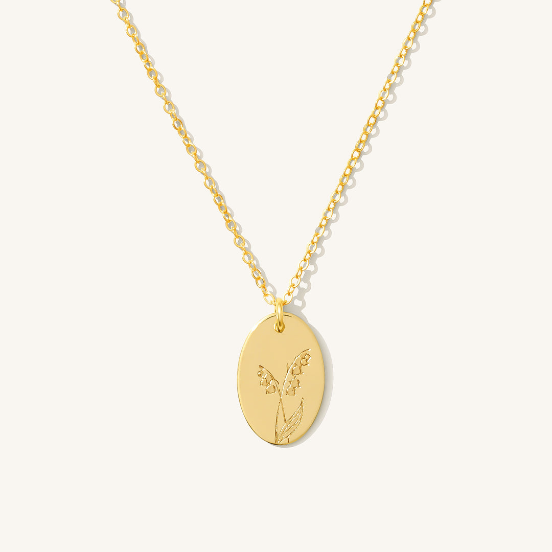 May Birth Flower Necklace in gold filled featuring a lily of the valley flower stamped on an oval disc pendant.