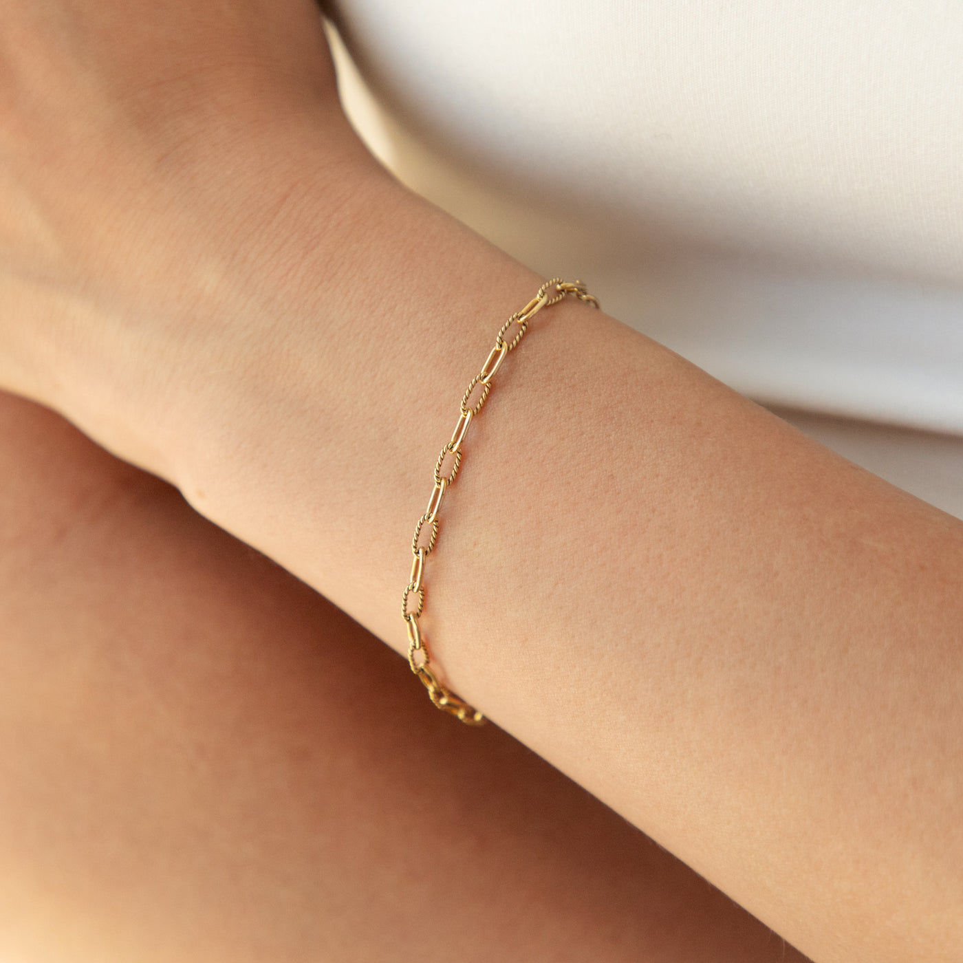Twisted Paperclip Chain Bracelet on woman's wrist