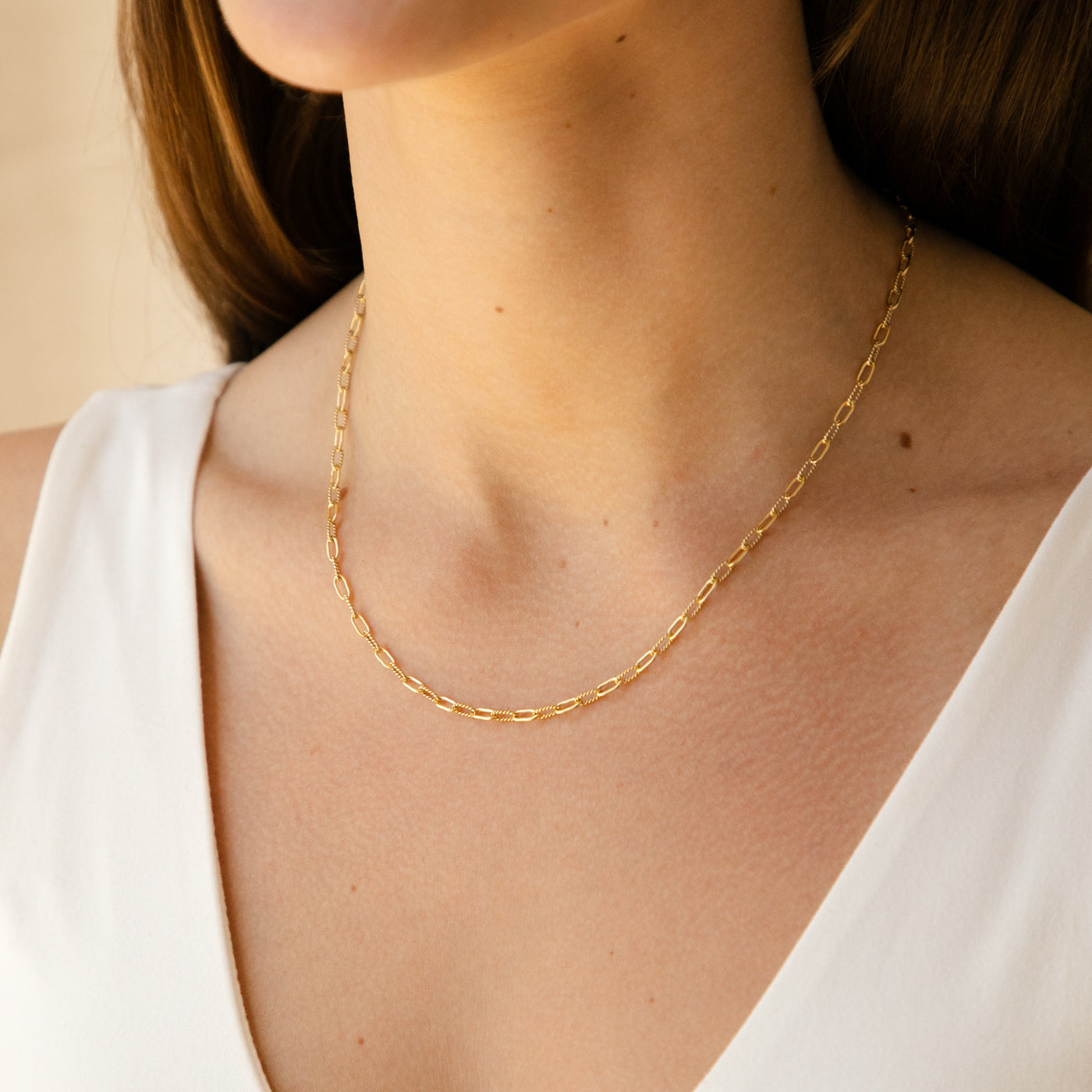 Woman's neck wearing Twisted Paperclip chain necklace
